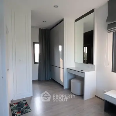 Modern minimalist bedroom with sleek design and ample natural light