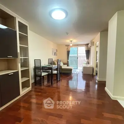 Spacious living room with elegant wooden flooring and modern dining area