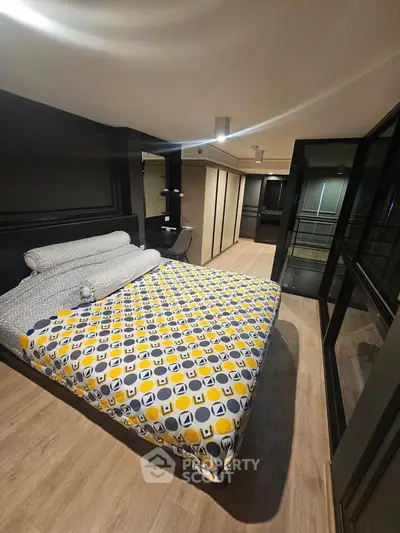 Modern bedroom with stylish decor and large windows offering ample natural light.