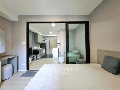 Modern studio apartment with open layout and sleek kitchen design