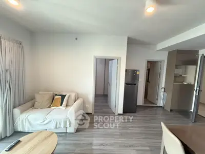 Spacious modern living room with sleek flooring and cozy sofa in a stylish apartment