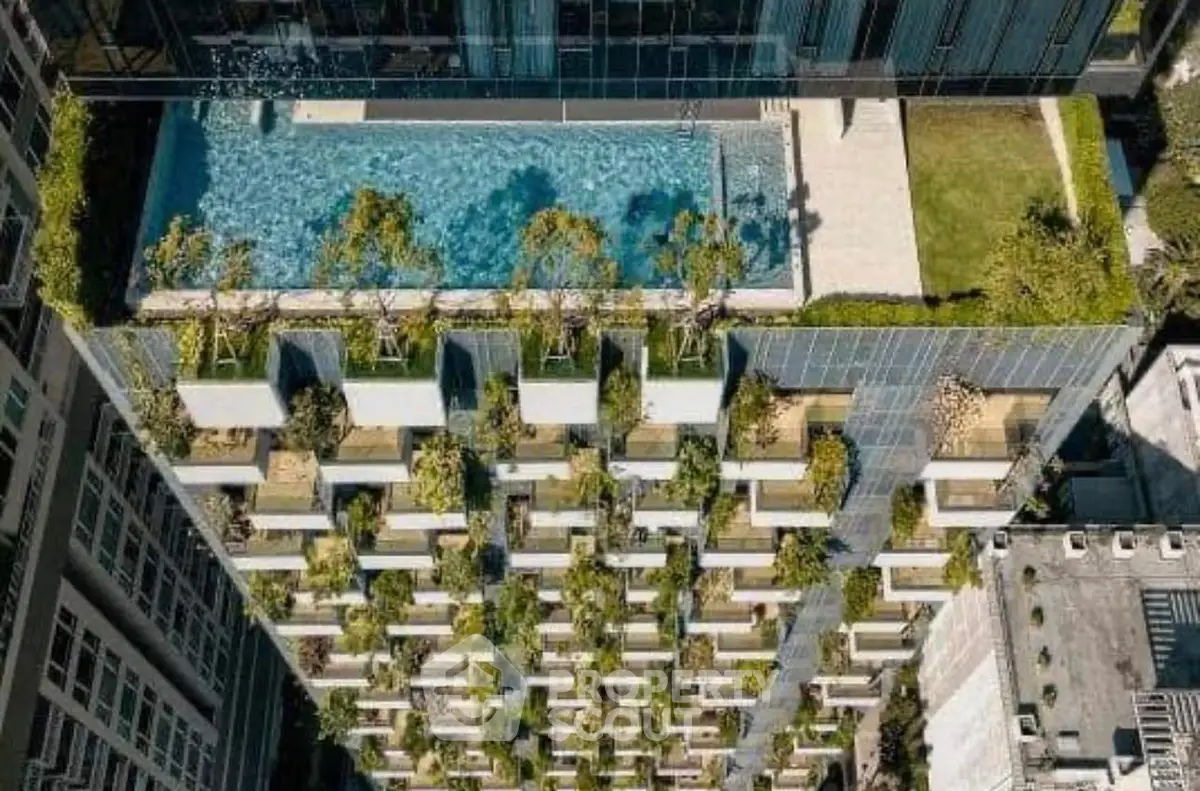 Stunning rooftop pool with lush greenery on a modern high-rise building.