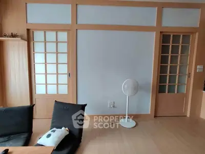 Modern living room with sliding wooden doors and minimalist decor