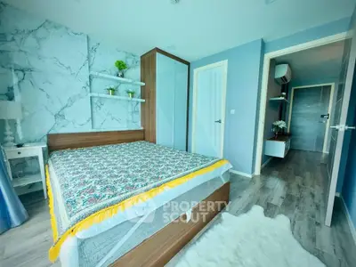Modern bedroom with stylish decor and wooden flooring in a contemporary apartment.