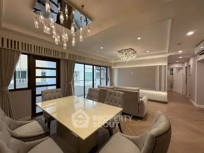 Luxurious living room with elegant chandelier and modern furniture in a spacious apartment.