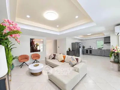 Spacious modern living room with elegant decor and open layout, featuring stylish furniture and ample natural light.