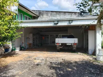 Spacious garage with a parked truck and ample storage space in a residential property.