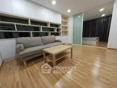 Modern living room with wooden flooring and cozy sofa