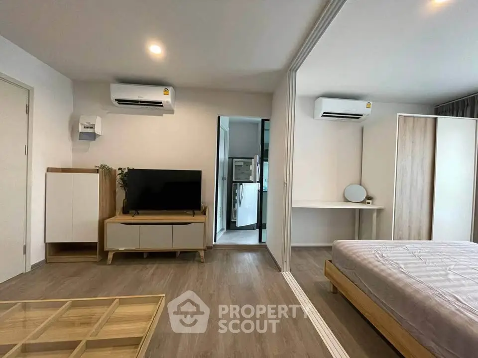 Modern studio apartment with sleek design, featuring air conditioning and stylish furniture.
