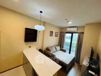 Modern living room with cozy sofa, stylish lighting, and balcony view in a contemporary apartment.