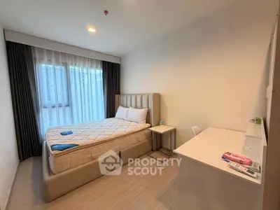 Modern bedroom with stylish bed and natural light, perfect for a cozy living experience.