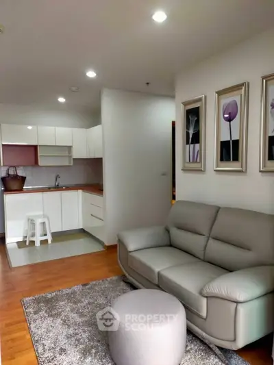 Modern living room with cozy sofa and open kitchen layout