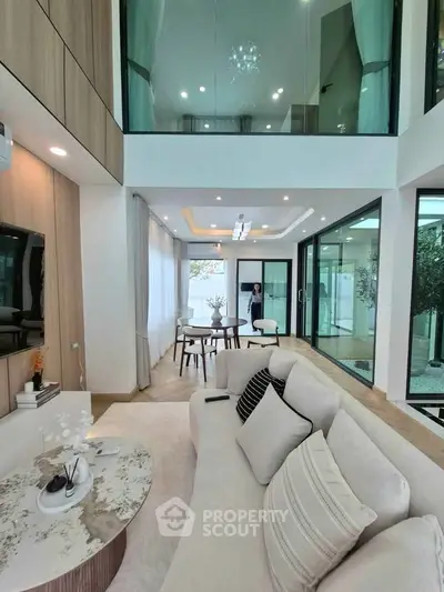 Luxurious modern living room with high ceilings and elegant decor