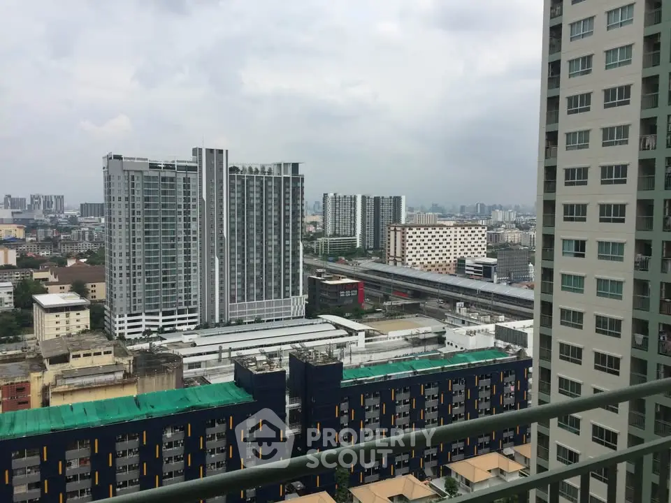 Stunning cityscape view from high-rise balcony overlooking urban skyline.