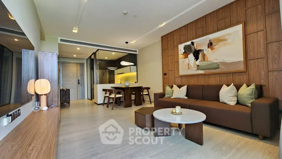 Modern living room with stylish decor and open layout, featuring a cozy sofa and elegant dining area.