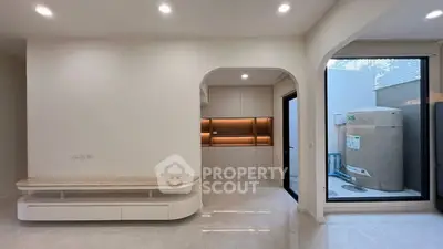 Modern minimalist interior with sleek built-in storage and large window view.