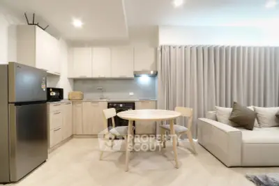 Modern open-layout kitchen and living room with sleek design and neutral tones.