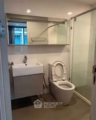 Modern bathroom with sleek fixtures and glass shower enclosure