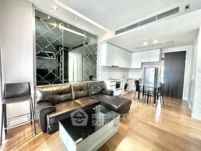 Modern living room with sleek furniture and open kitchen layout in luxury apartment