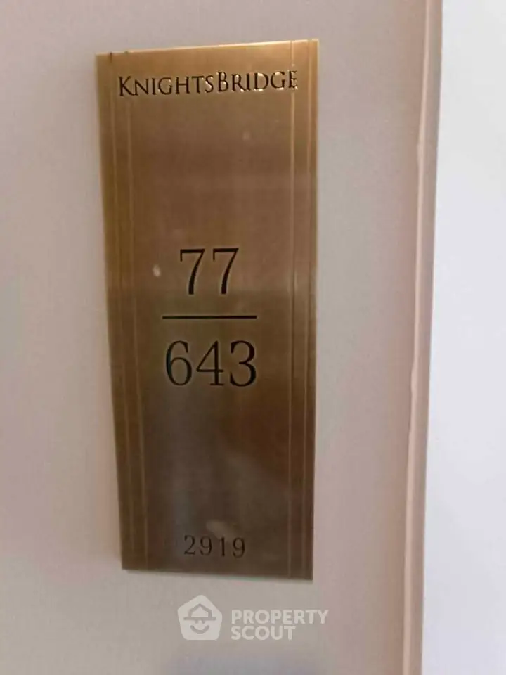 Elegant brass door number plaque in Knightsbridge building