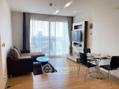 Spacious modern living room with city view, featuring sleek furniture and natural light.
