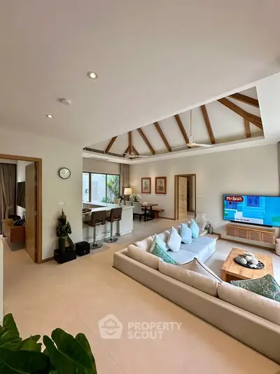Spacious living room with vaulted ceiling and modern decor in a luxury home