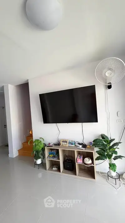 Modern living room with wall-mounted TV and stylish decor