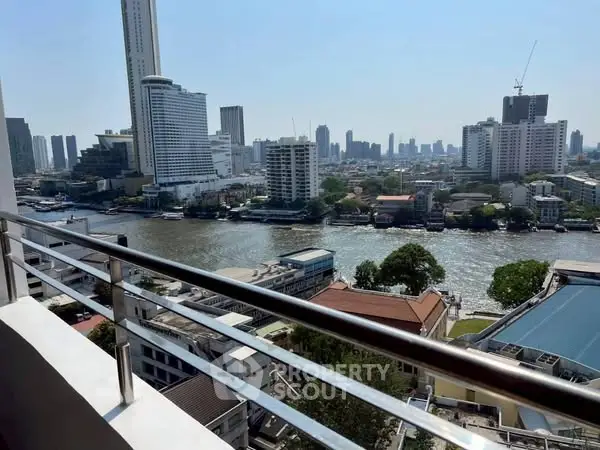 Stunning cityscape view from a high-rise balcony overlooking a river and skyline.