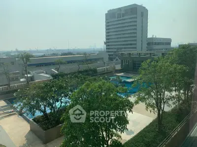 Stunning rooftop pool with lush greenery and cityscape views, perfect for relaxation and leisure.