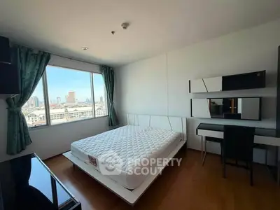 Spacious bedroom with city view, modern furniture, and ample natural light.