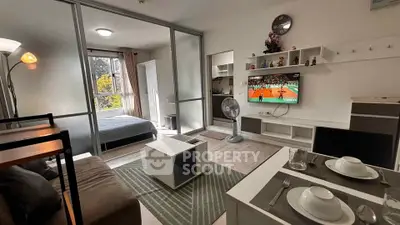 Modern studio apartment with open layout, featuring a cozy living area and stylish kitchen.