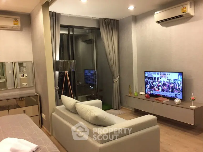 Modern living room with sleek furniture and large window view