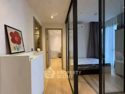 Modern bedroom with glass partition and wooden flooring