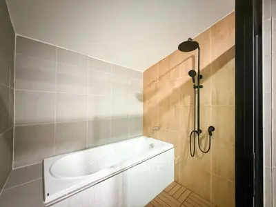 Modern bathroom with sleek bathtub and stylish shower fixtures
