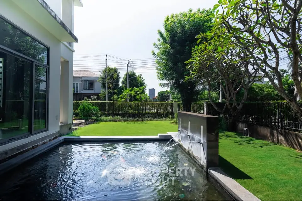 Luxurious garden with private pool and lush greenery in a serene residential area.