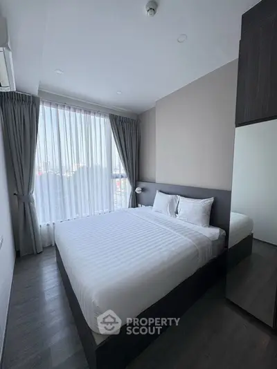 Modern bedroom with large window and stylish decor