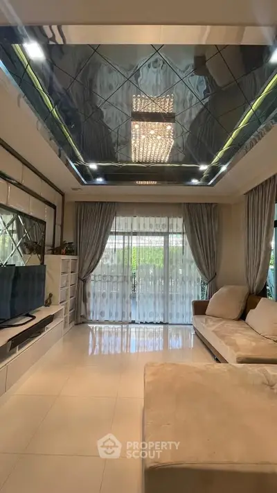 Luxurious living room with modern ceiling design and elegant furnishings