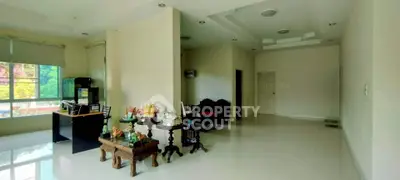 Spacious living room with elegant decor and large windows for natural light.