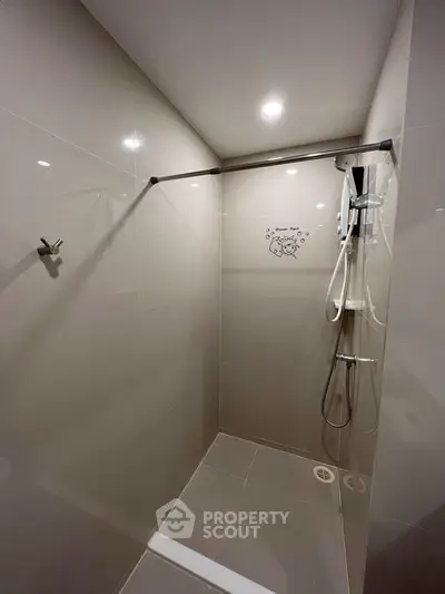Modern bathroom with sleek shower design and neutral tiles, perfect for a contemporary home.