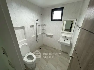 Modern bathroom with sleek white tiles and minimalist fixtures