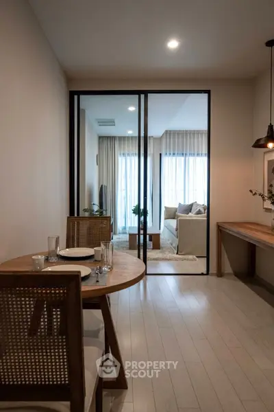 Modern open-plan living and dining area with elegant decor and natural light.