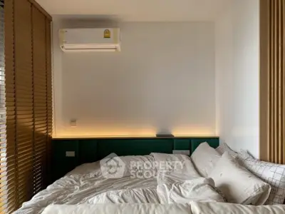 Cozy bedroom with modern air conditioning and stylish blinds, perfect for relaxation and comfort.