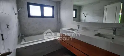 Modern bathroom with dual sinks and bathtub in elegant design