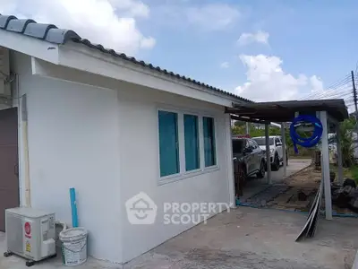 Charming single-story home with carport and modern windows, perfect for cozy living.