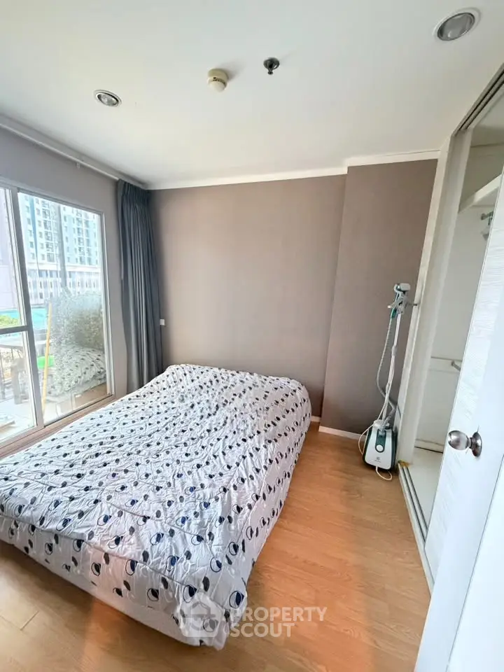 Cozy bedroom with large window and modern decor in urban apartment