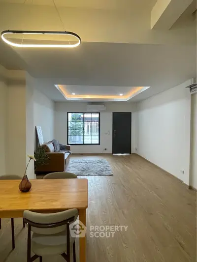 Spacious modern living room with elegant lighting and wooden flooring