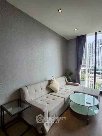 Modern living room with elegant sofa and city view from window.