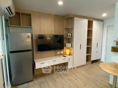 Modern living room with built-in storage and sleek TV setup in stylish apartment.