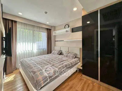 Modern bedroom with stylish decor and large window for natural light