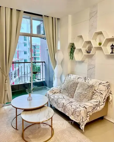 Chic living room with modern decor and balcony view in urban apartment